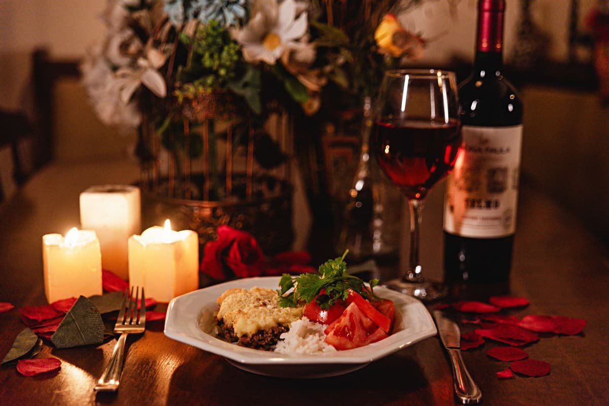 Candlelit dinner table with wine